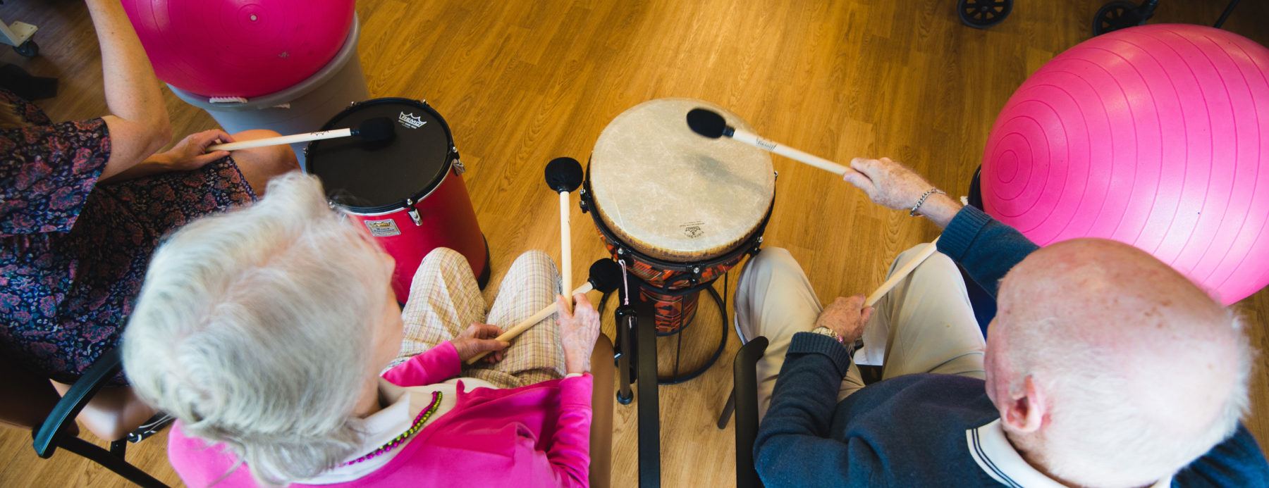 Three people playing drums