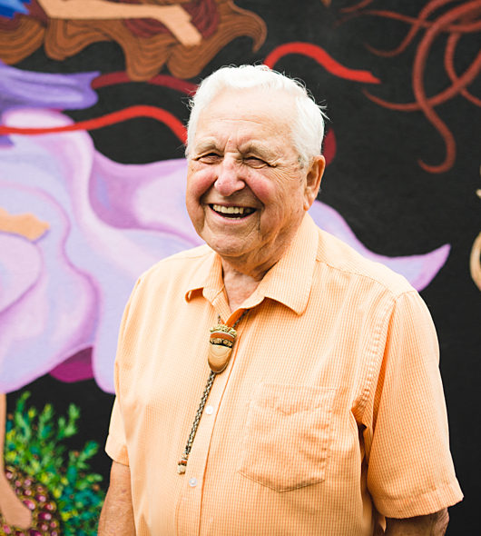 Man in front of a mural