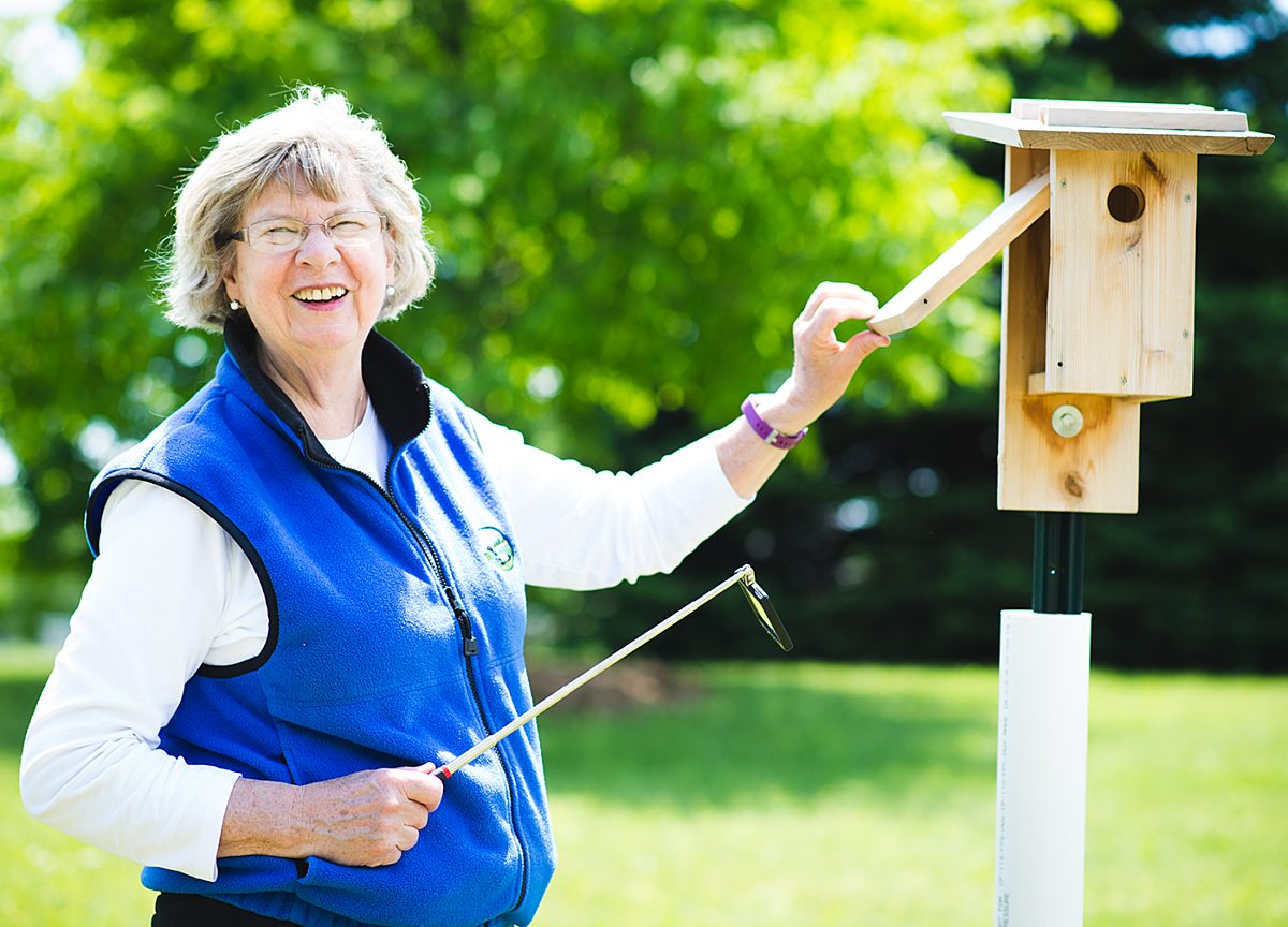 Woman with a bluebird house